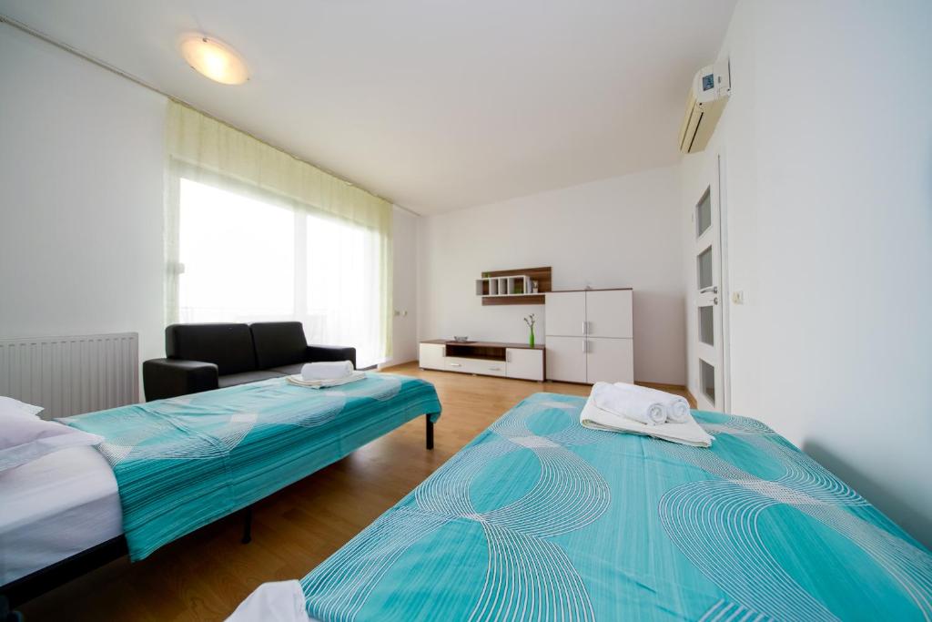 Posteľ alebo postele v izbe v ubytovaní Apartments L&L