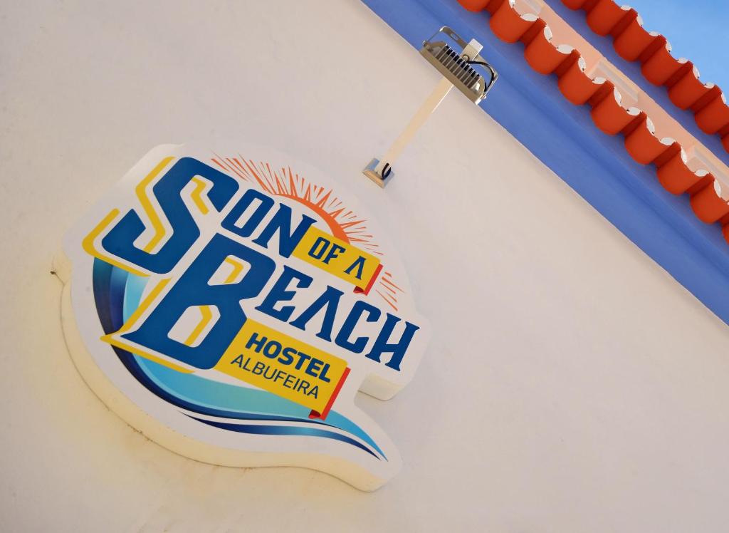 a baseball sign on a wall with a baseball bat at Son of a Beach Hostel in Albufeira