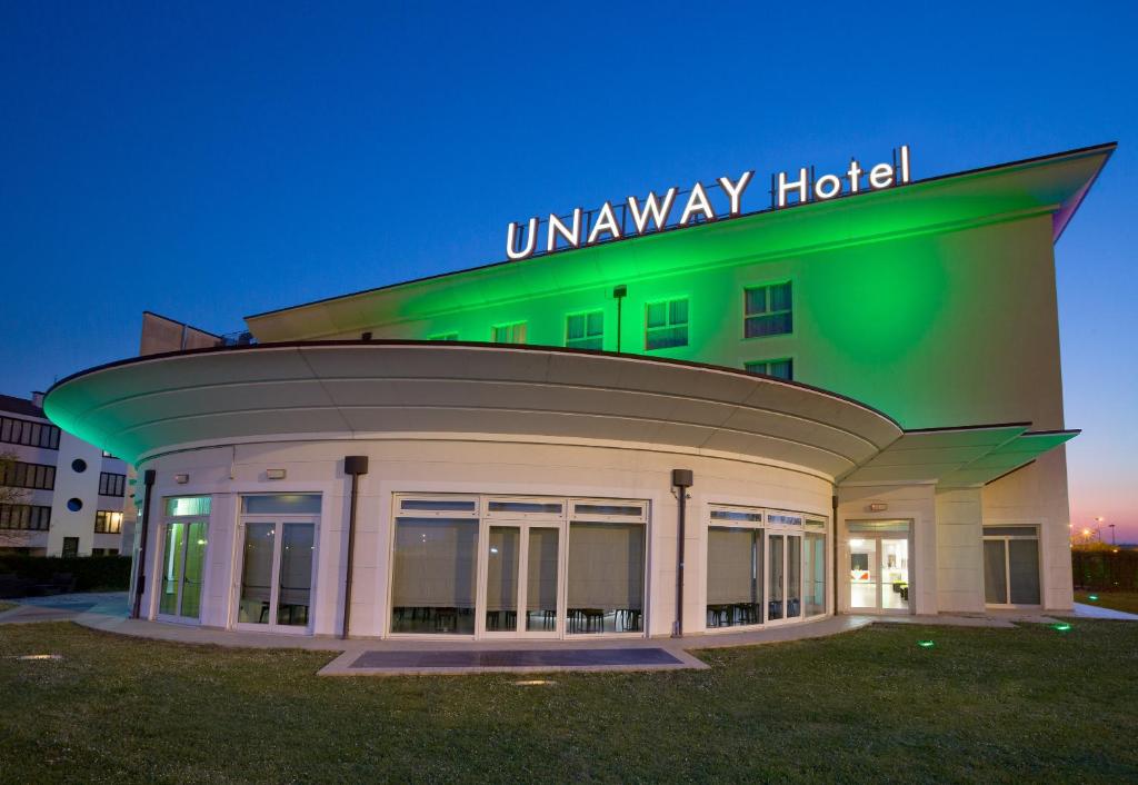 a building with anaway hotel sign on top of it at UNAWAY Cesena Nord in Cesena