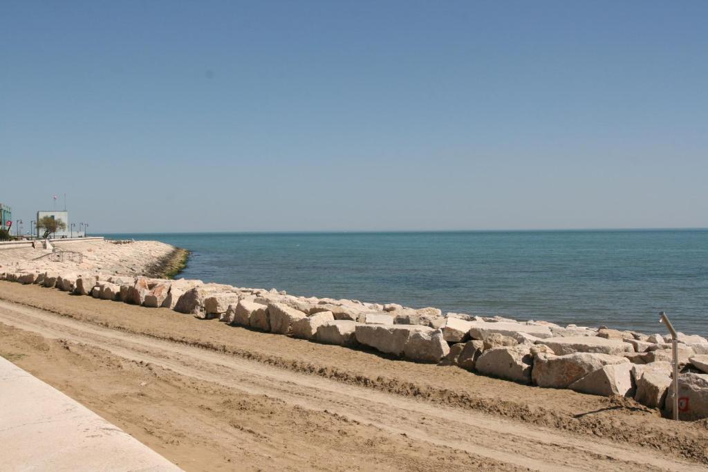 una fila di rocce su una spiaggia vicino all'acqua di Casa Sangion a Caorle