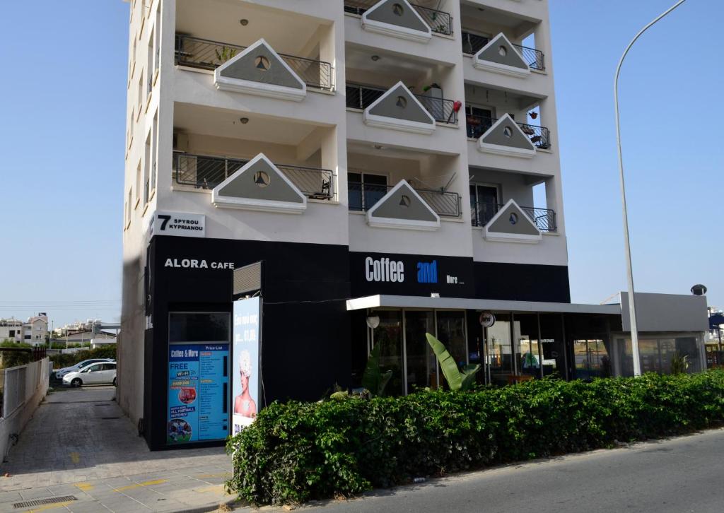 a building with a chile clinic sign in front of it at Alora Apartments in Larnaca