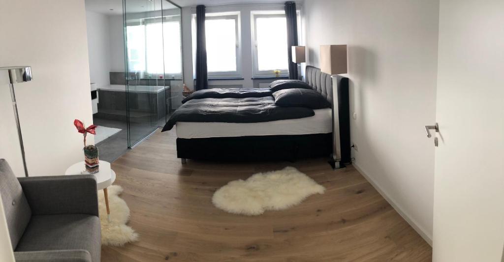 a bedroom with two beds and a rug on a wooden floor at Apartment Central Würzburg in Würzburg