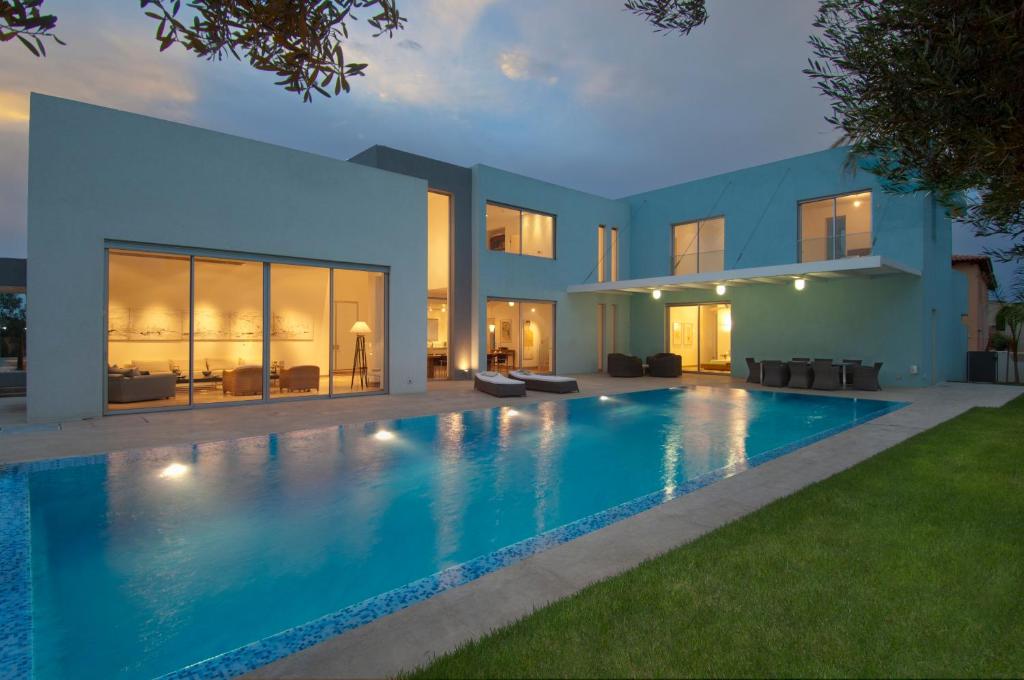 a swimming pool in the backyard of a house at Villa Alice Caesarea in Caesarea