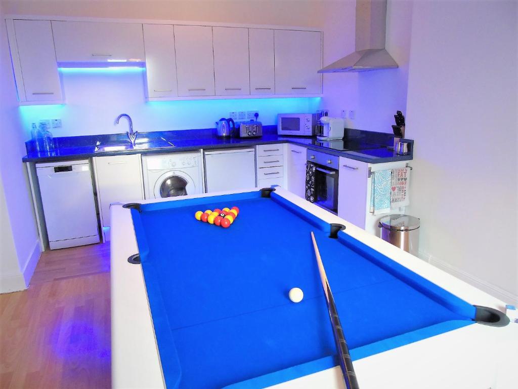a pool table in the middle of a kitchen at Snug - Tùr Sealladh Apartment in Helensburgh