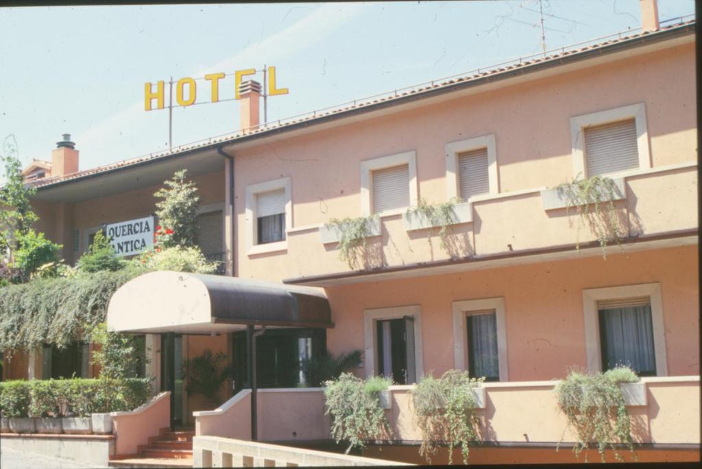 a hotel with a sign on the side of it at Hotel Quercia Antica in San Marino