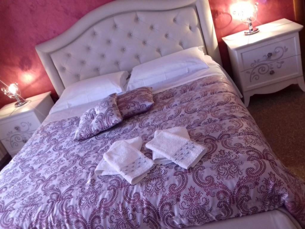 a purple bed with two pillows and two night stands at Casa Vacanza Nonna Dora in Matera
