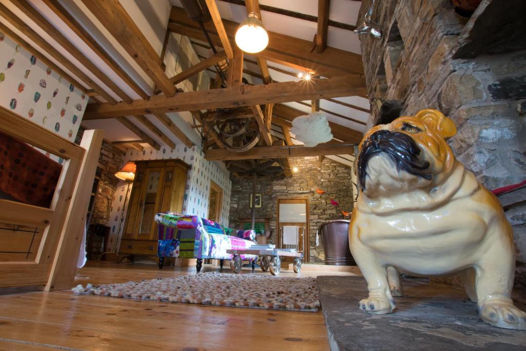 a statue of a dog sitting on the floor in a room at Low Mill Guesthouse in Bainbridge
