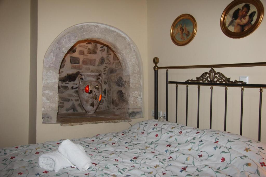 a bedroom with a bed and a painting on the wall at Polyxenia Hotel in Nafplio