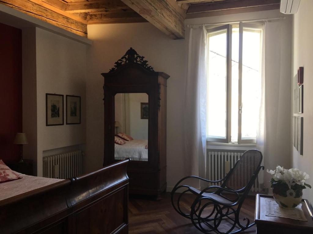 a bedroom with a mirror and a bed in it at B&B L'Affresco in Mantova