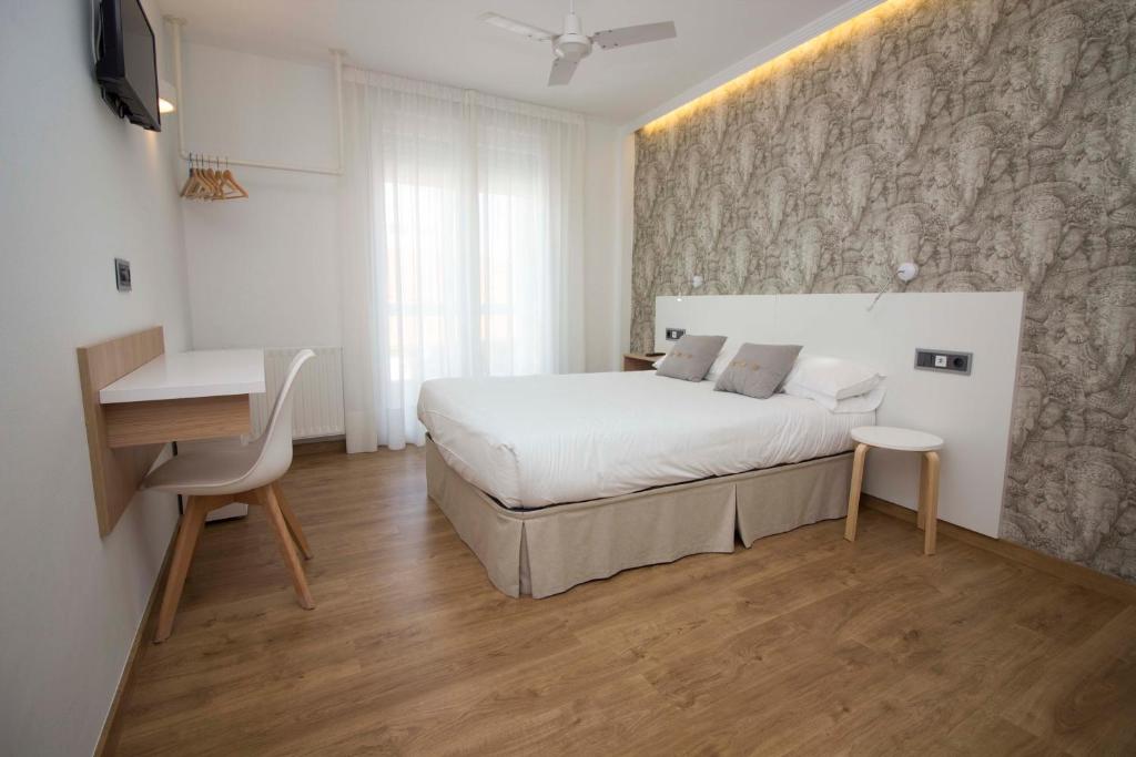Postel nebo postele na pokoji v ubytování Hotel Vilagarcia