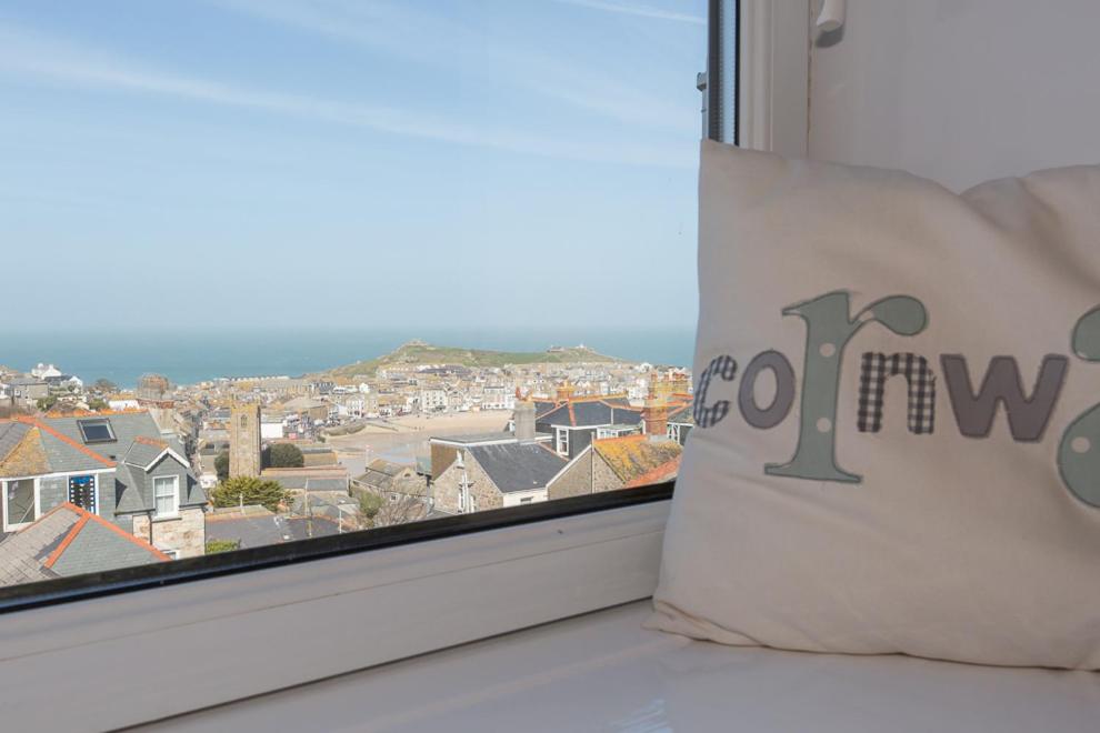 a pillow on a window with a view of a city at 3 Porthminster B&B in St Ives