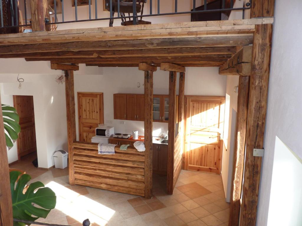 a kitchen with wooden cabinets and a counter top at Ubytování Podolí U Křížku in Telč