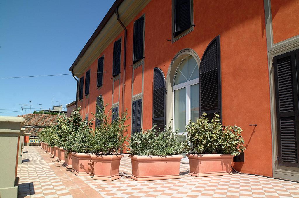a row of windows in front of a building at Residence Corte della Vittoria in Parma