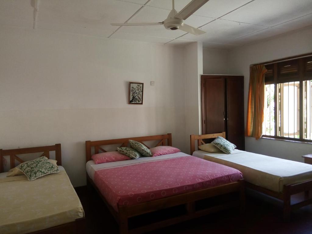 Postel nebo postele na pokoji v ubytování Hotel Mango Garden
