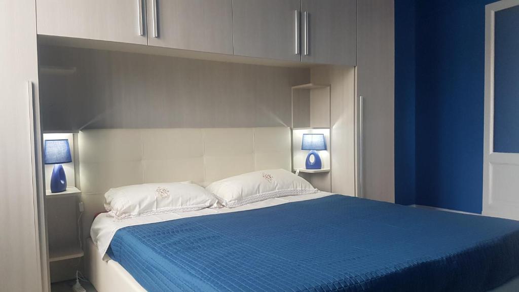 a bedroom with a blue and white bed with two pillows at JustBlue - Città Studi/Piola/Lambrate in Milan