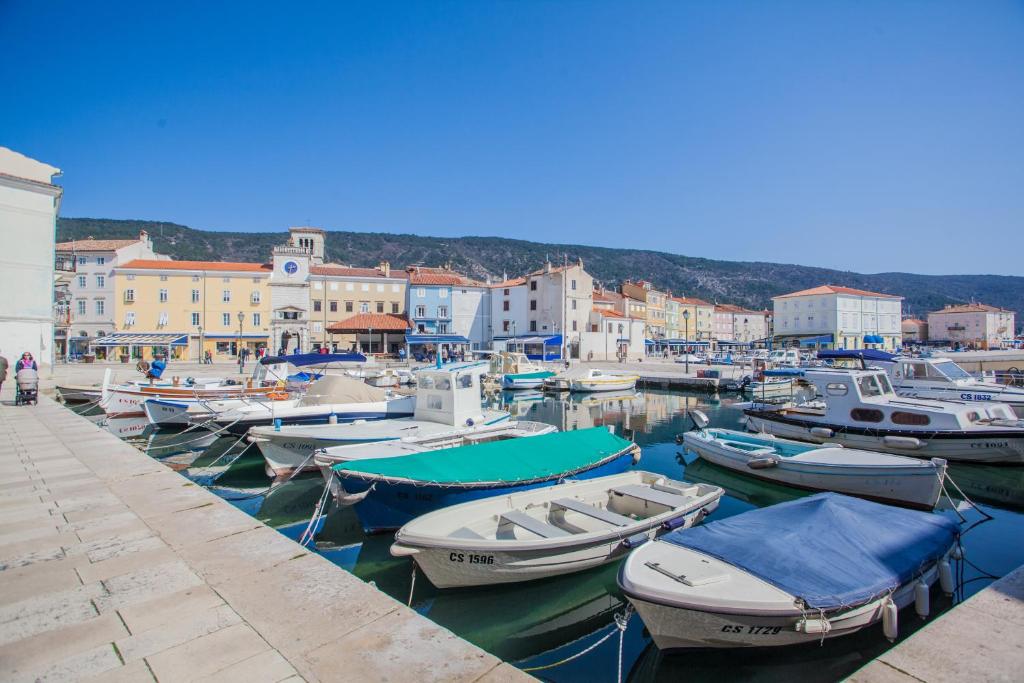 a bunch of boats are docked in a harbor at Apartments Dabović in Cres