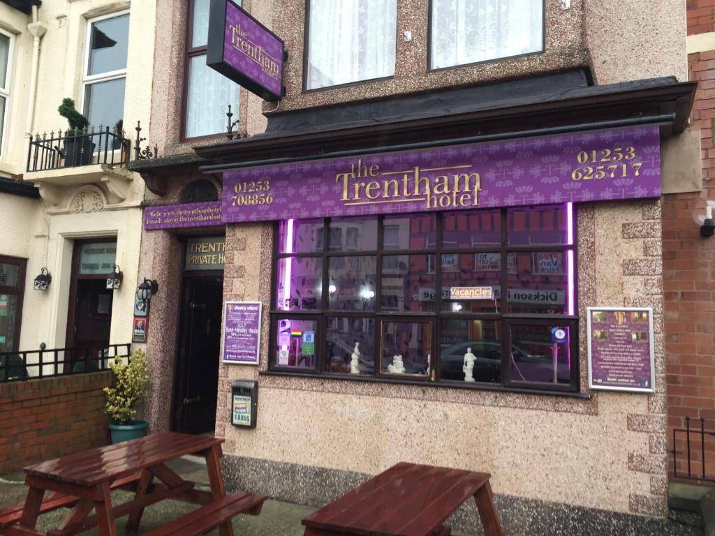 a restaurant with two picnic tables in front of it at The Trentham Hotel in Blackpool