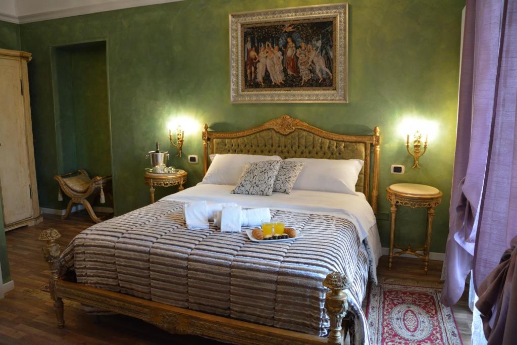 a bedroom with a bed with a plate of food on it at Le Stanze del Console in Gravina in Puglia