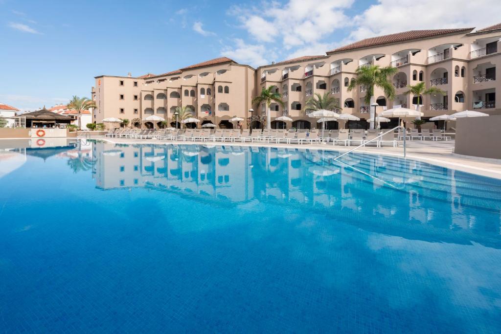 a large swimming pool in front of a hotel at Saint George in Los Cristianos