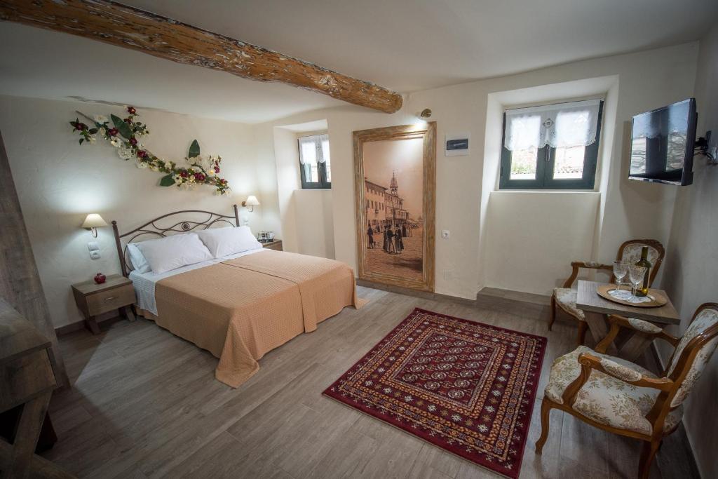 a bedroom with a bed and a red rug at Vorto House in Agios Leon