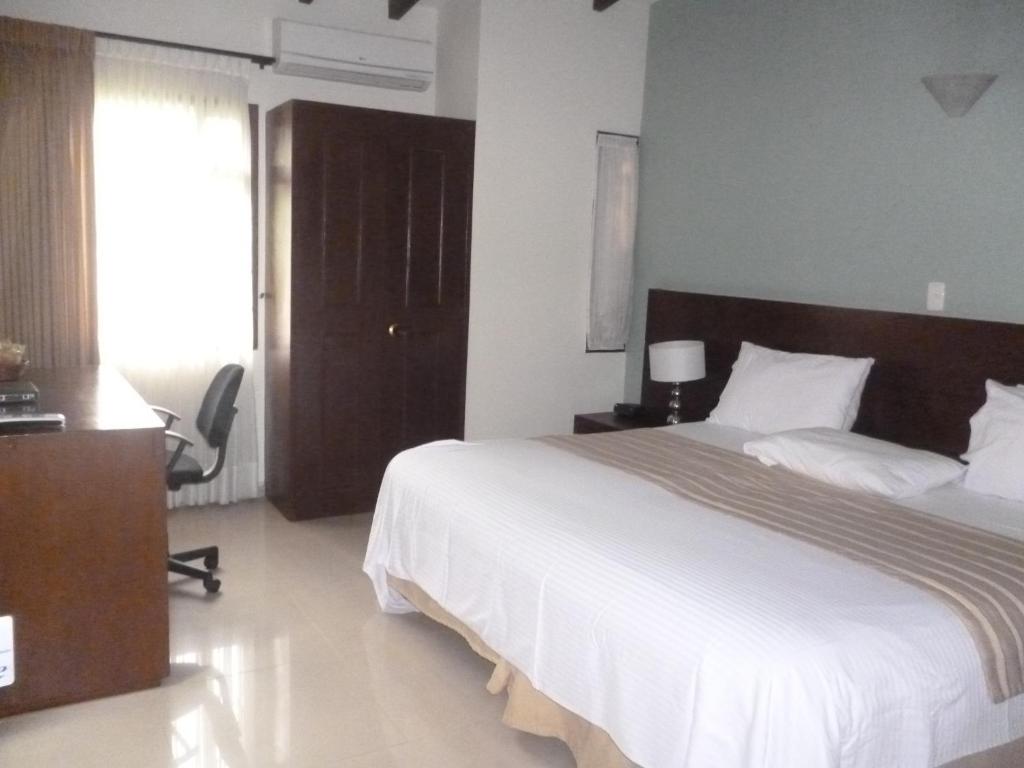 Postel nebo postele na pokoji v ubytování Hotel Poblado Campestre