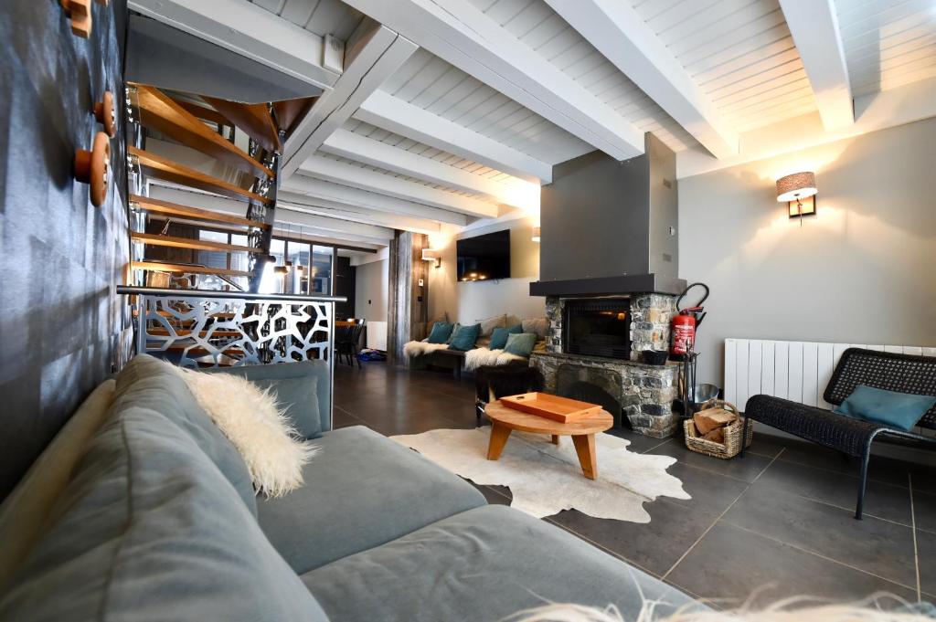 a living room with a couch and a fireplace at Au Selaou 34 in Val Thorens