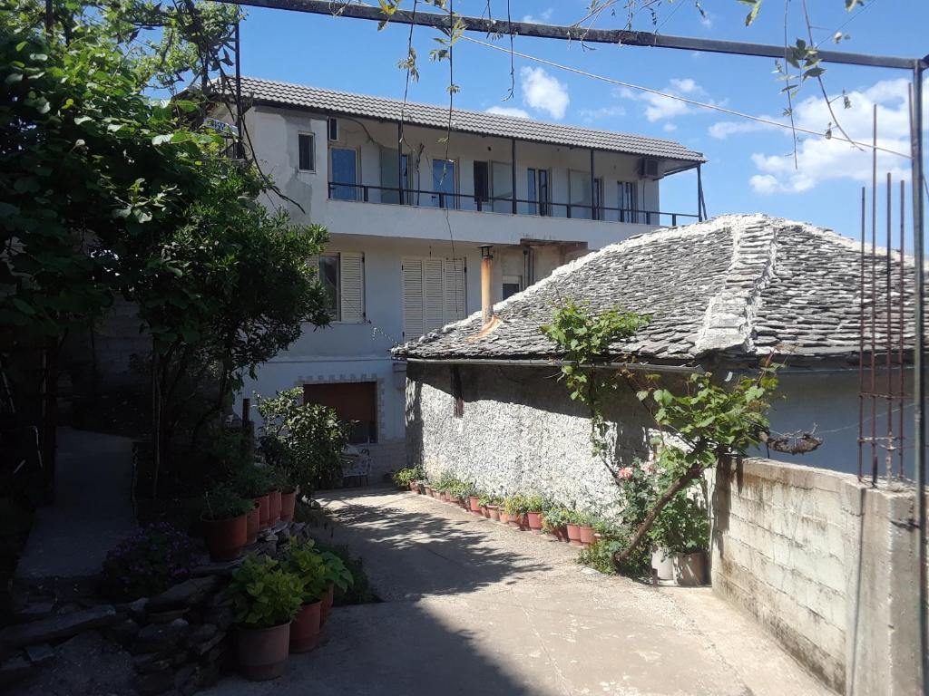 a large white building with a pathway in front of it at Guesthouse Shtino in Gjirokastër