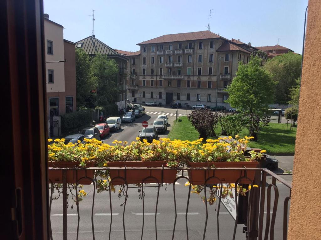 a balcony with a bunch of flowers on a street at Villa Gioia in Milan