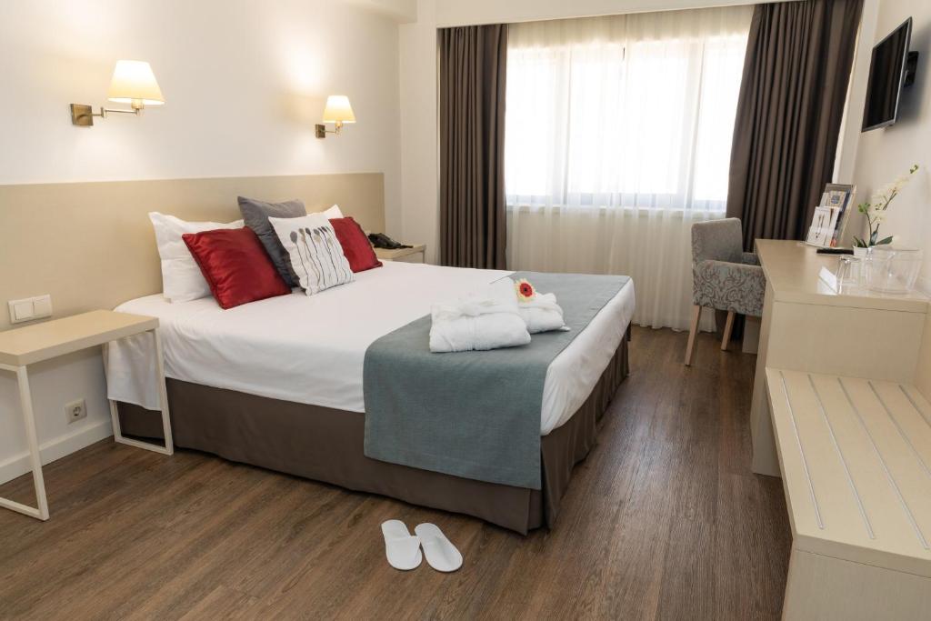 Cama ou camas em um quarto em Hotel Black Tulip - Porto Gaia
