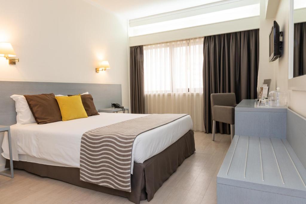 Tempat tidur dalam kamar di Hotel Black Tulip - Porto Gaia