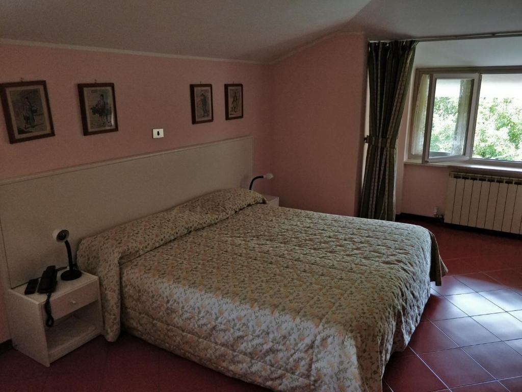 Postel nebo postele na pokoji v ubytování Hotel Barolo Classico