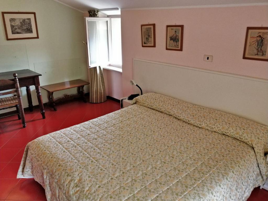 Postel nebo postele na pokoji v ubytování Hotel Barolo Classico