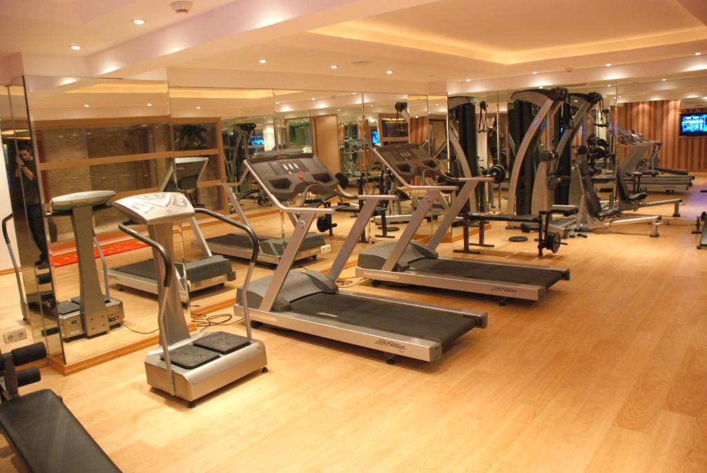 a gym with a bunch of treadmills and ellipticals at Mosaic Hotel Old City -Special Category in Istanbul