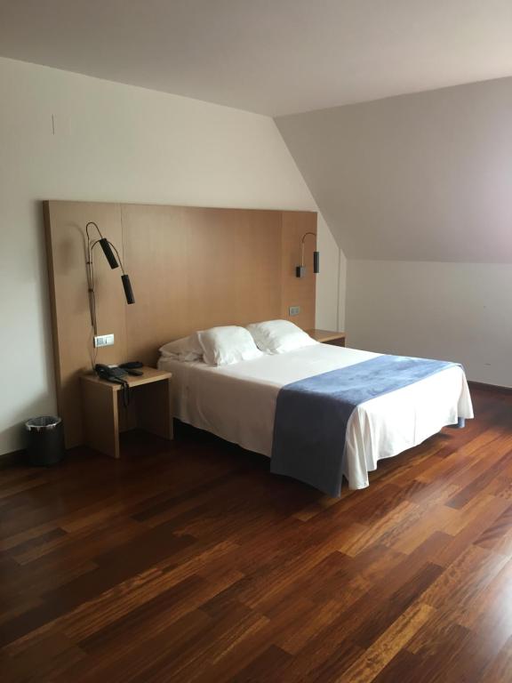 A bed or beds in a room at Hotel Ril