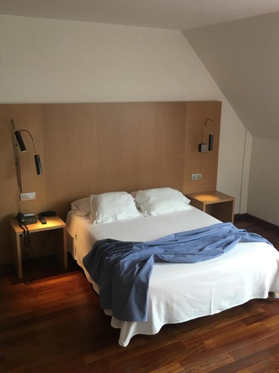 A bed or beds in a room at Hotel Ril