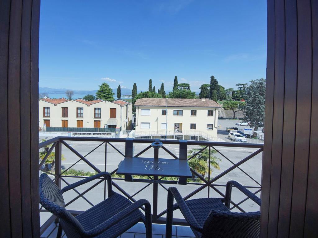 a balcony with chairs and a view of a parking lot at Hotel Dori in Peschiera del Garda