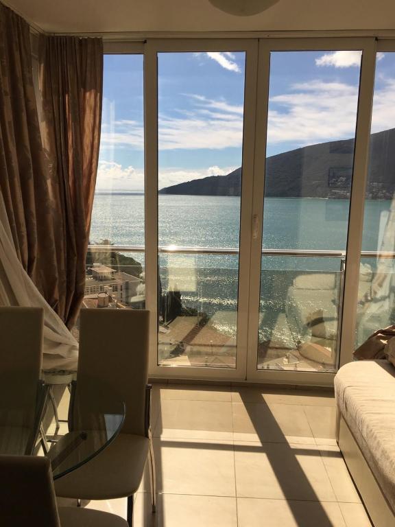a living room with a view of the ocean at Penthouse View HN in Herceg-Novi