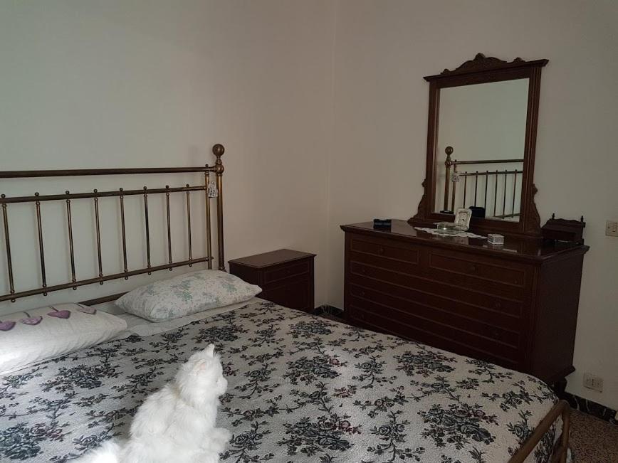 a bedroom with a bed and a dresser and a mirror at Casa di NELLA in Campiglia Marittima