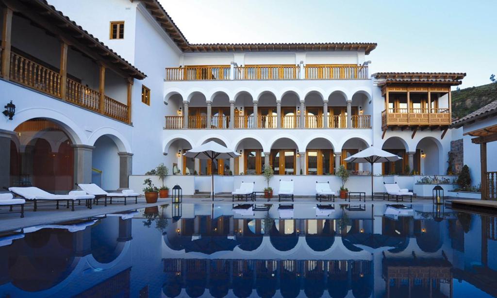 a hotel with a pool in front of a building at Palacio Nazarenas, A Belmond Hotel, Cusco in Cusco