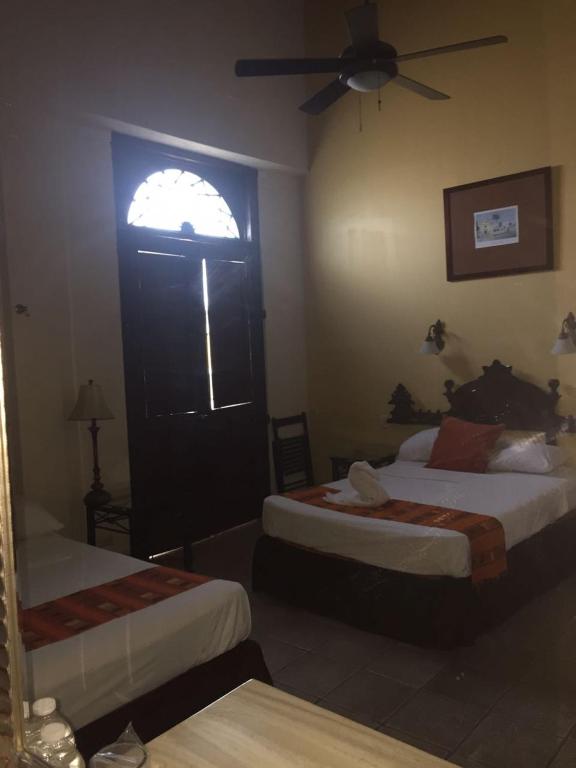 Postel nebo postele na pokoji v ubytování Hotel San Miguel Arcangel