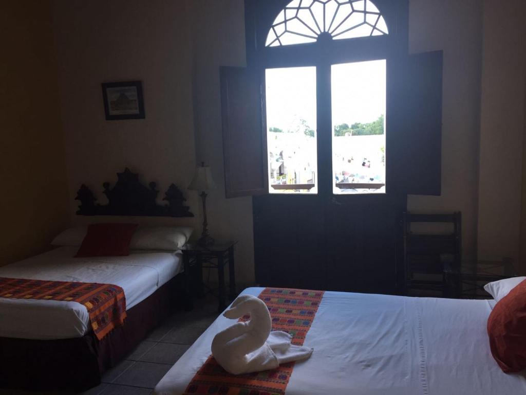 Postel nebo postele na pokoji v ubytování Hotel San Miguel Arcangel