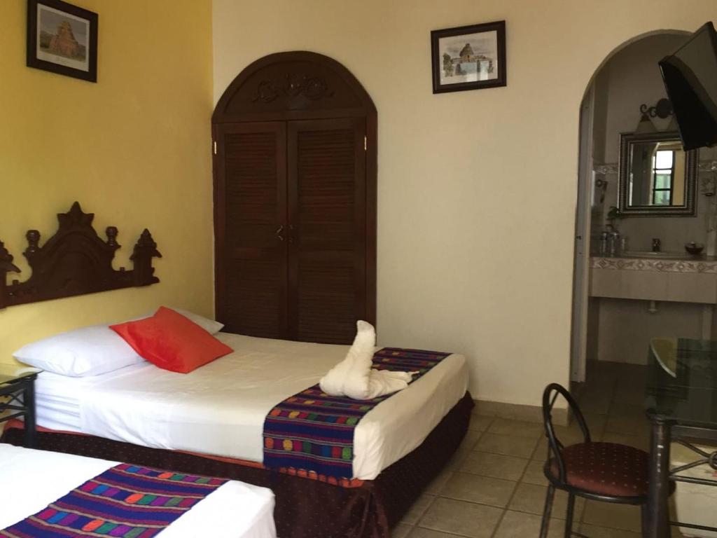 Postel nebo postele na pokoji v ubytování Hotel San Miguel Arcangel