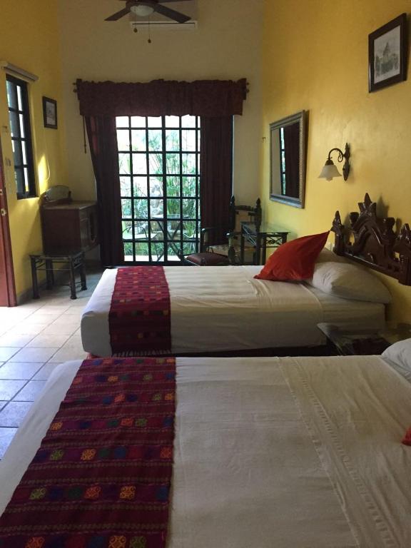 Postel nebo postele na pokoji v ubytování Hotel San Miguel Arcangel