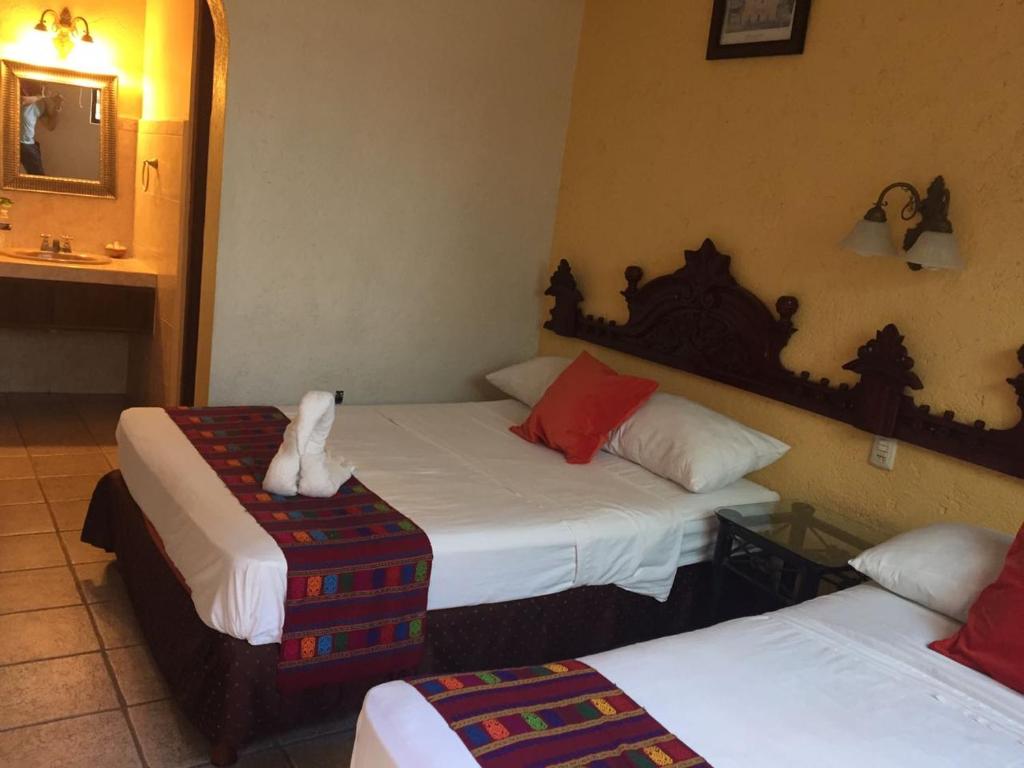 Postel nebo postele na pokoji v ubytování Hotel San Miguel Arcangel