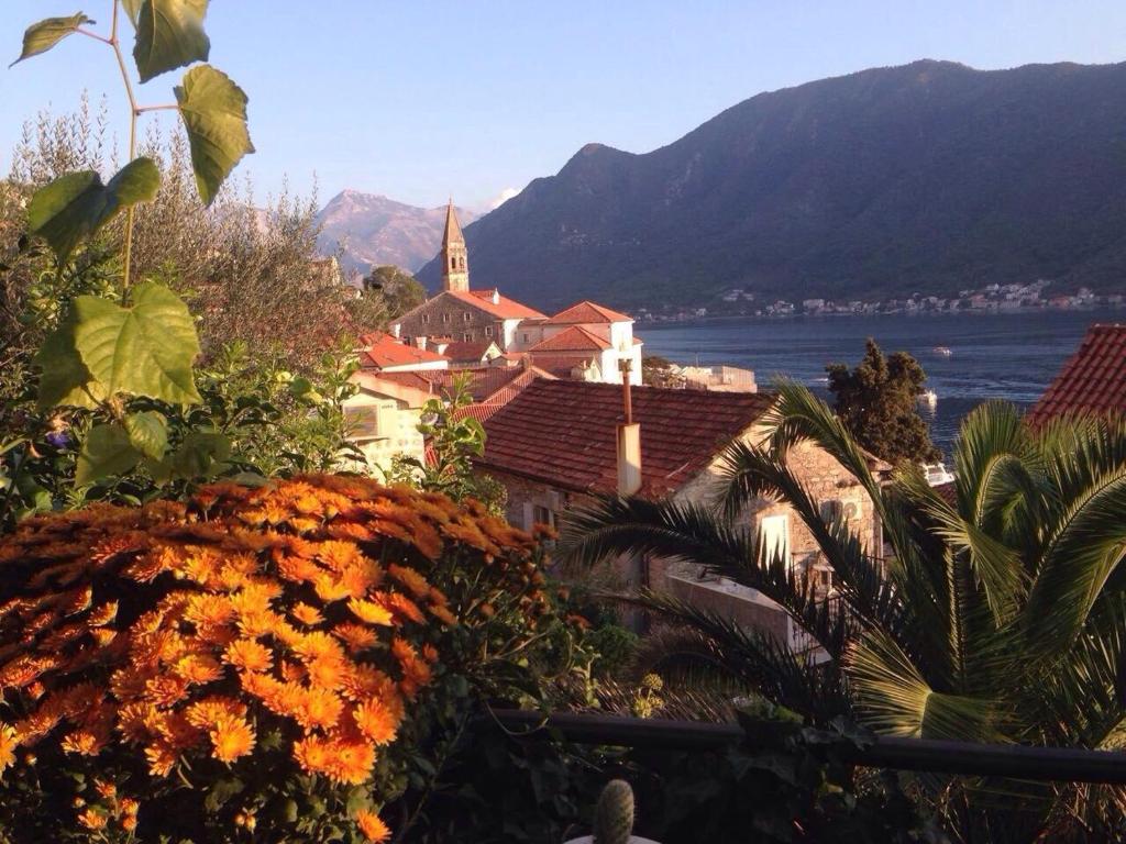 a town with a view of the water and mountains at Be happy in Perast in Perast