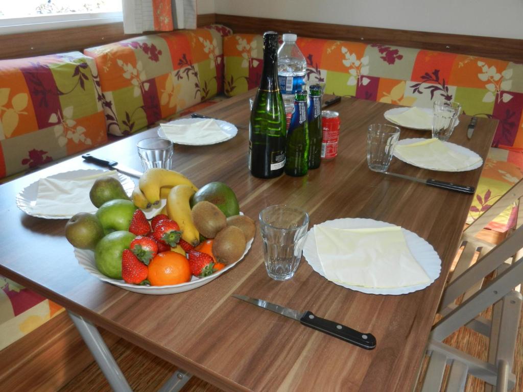 a wooden table with a bowl of fruit on it at Mareva37 in Trogues