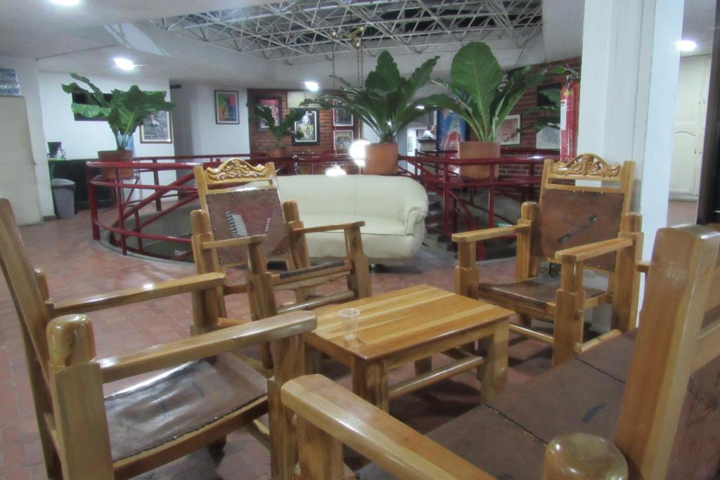 a room with chairs and a table and a couch at Hotel Nuevo Tio in Valledupar
