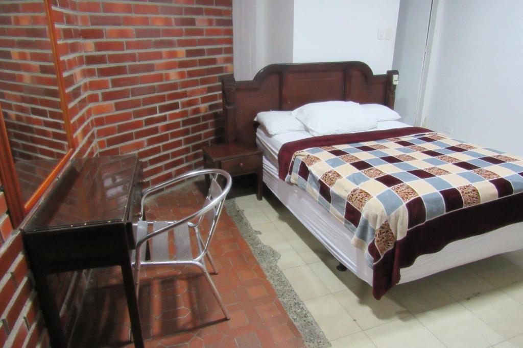 Postel nebo postele na pokoji v ubytování Hotel Nuevo Tio