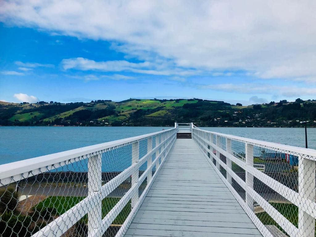 a wooden bridge over a body of water at Harbourview Stadium Hotel in Dunedin