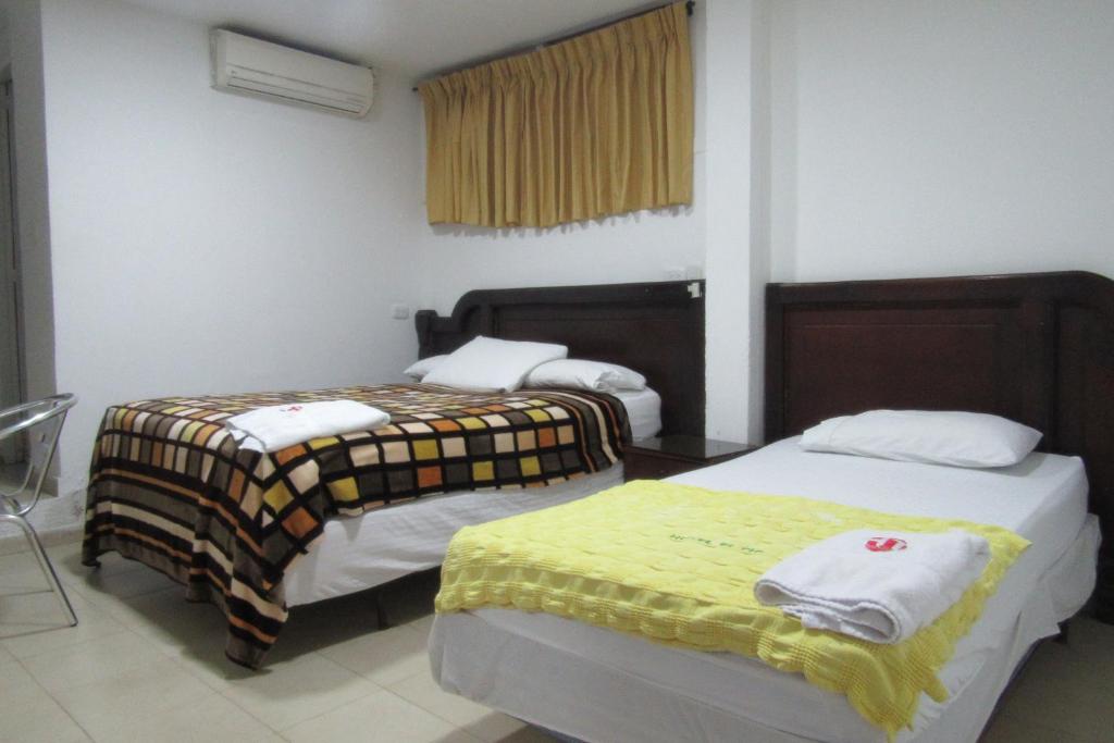 Postel nebo postele na pokoji v ubytování Hotel Nuevo Tio